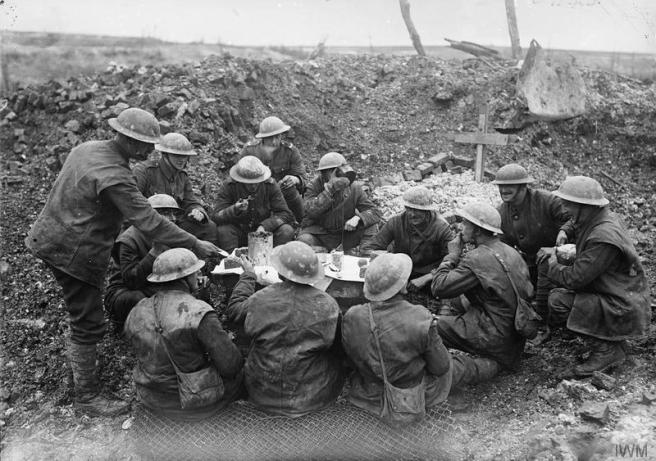 British troops eating their Christmas dinner in a shell hole, Beaumont Hamel, 25th December 1916.